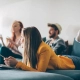 Four friends enjoying the living room together in the blog on blissful living in a shared flat.