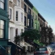 Apartment in different colors and cars along the street in this blog about London's Shared Housing.