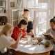 Students studying in a dining room as featured in the Guide for London Student Flatsharing blog.