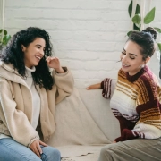 Two girls seating on a couch in this Comprehensive Guide to Shared Living blog.