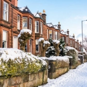 Apartment with snow on the street in Winter Property Maintenance blog.