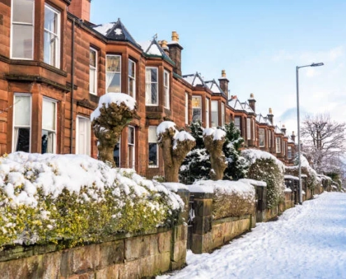 Apartment with snow on the street in Winter Property Maintenance blog.